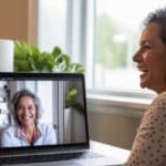 Hispanic woman in her 60s at home during a telemedicine appointment.