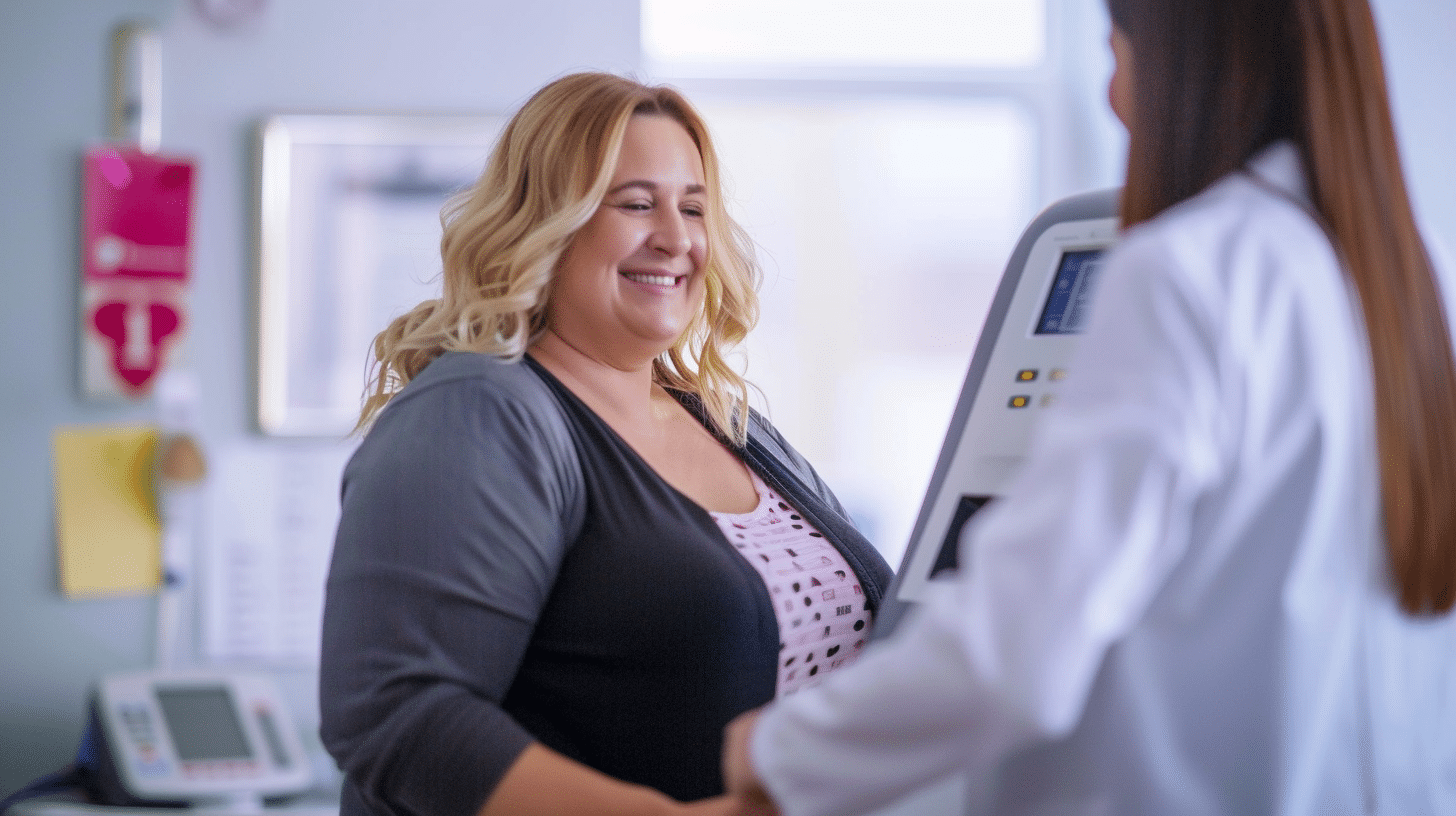 An image of a smiling slightly overweight female receiving her body mass index measurement in a body composition analyzer at a clinic, with clinic staff assisting her.